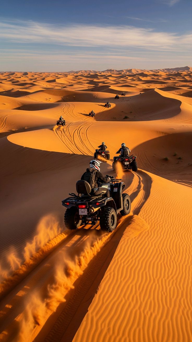 Quad bike kicking up sand on a desert track